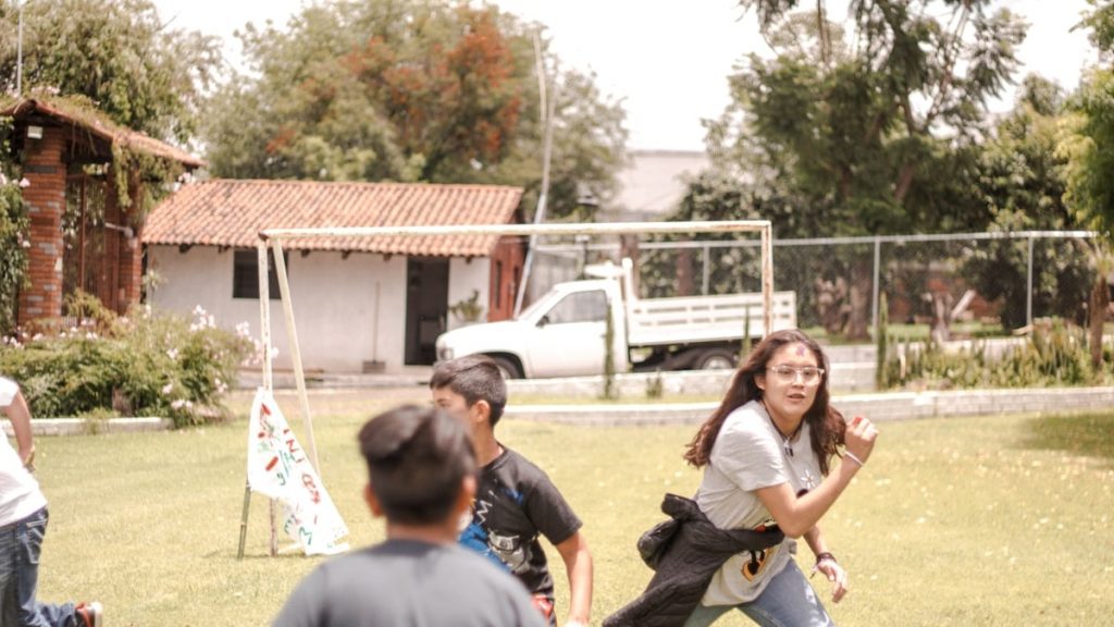 a group of people playing in a yard